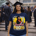 Graduate wearing a navy blue t-shirt with personalized 'Graduate 2026' design, standing in a graduation ceremony.