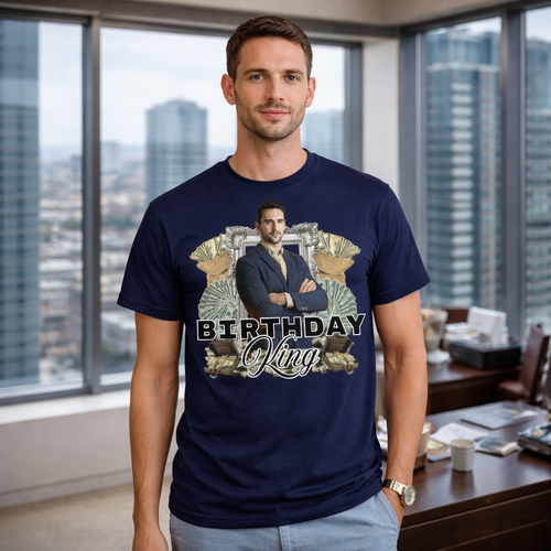 Man wearing a navy blue t-shirt with a graphic design in an office setting